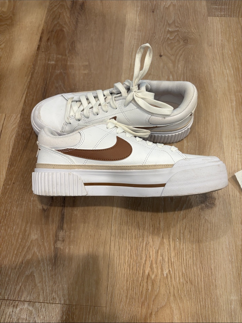 Nike Women’s White Platform Sneakers with Brown Swoosh
